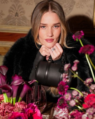 Rosie Huntington-Whiteley sleek black gown with luxurious fur coat.