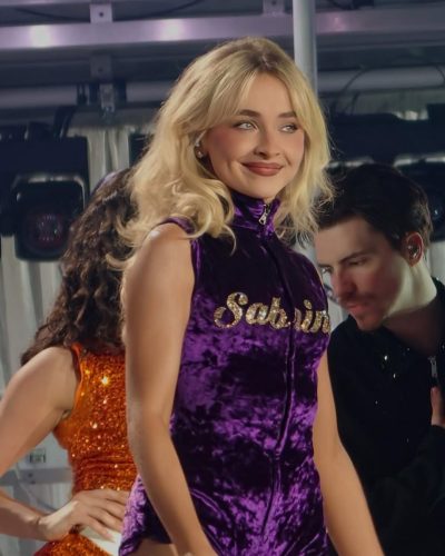 Sabrina Carpenter in sparkling blue dress with soft wave hairstyle.