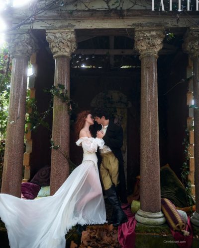 Sadie Sink in a black lace gown with flowing fabric.
