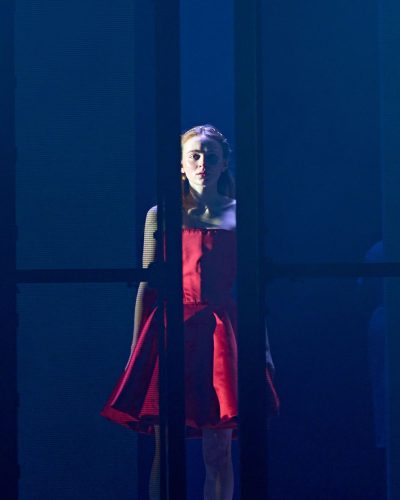 Sadie Sink wearing dramatic red dress with intricate details.