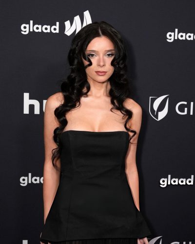 Samantha Lux in black dress with clean lines and shine