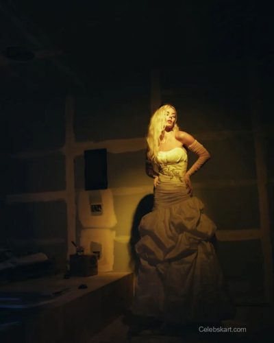 Samara Weaving in white gown with flowing fabric catching light