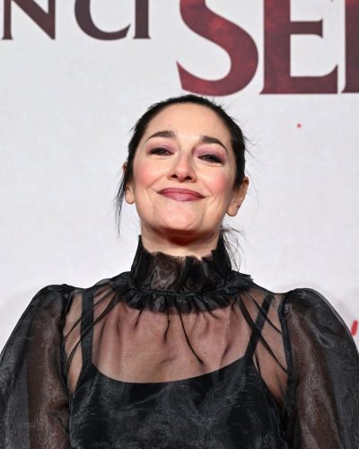 Sara Ricci in a flowing black sheer blouse