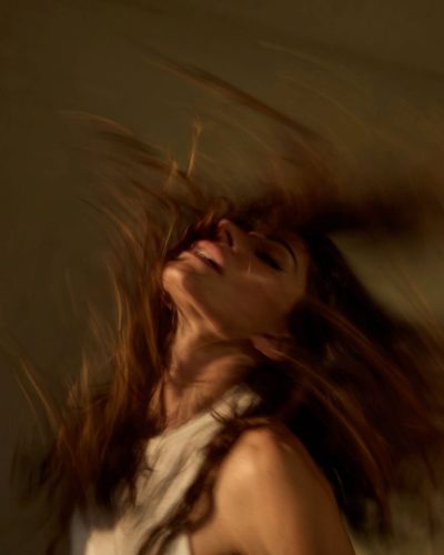 Sarah Shahi in classic white tank top and distressed blue jeans