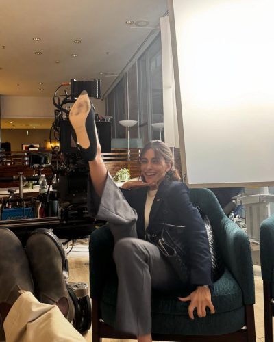 Sarah Shahi deep blue velvet jacket layered with accessories