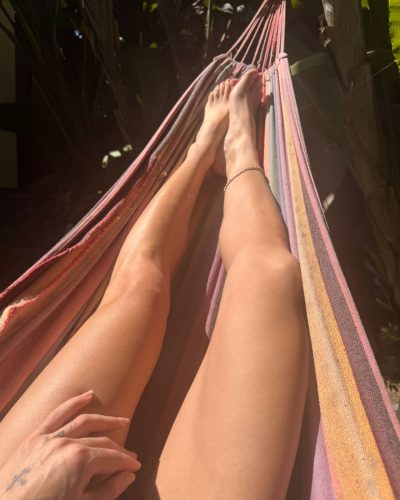 Sarah Shahi casual fitted jeans and deep blue velvet jacket