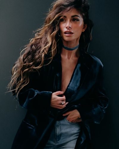 Sarah Shahi deep blue velvet jacket and fitted jeans