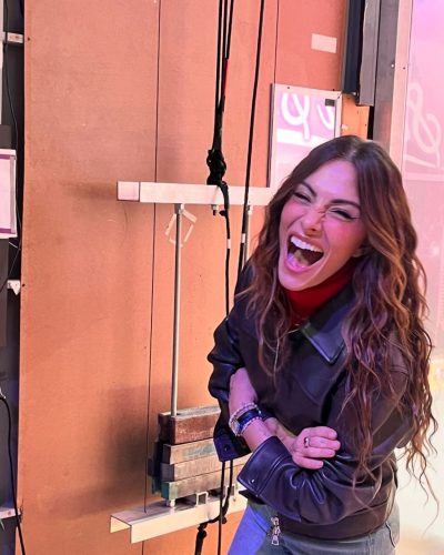 Sarah Shahi modern deep blue velvet jacket with jeans