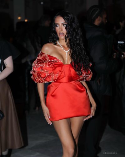 Seerat Saini dressed in a red gown with luxurious fabric.