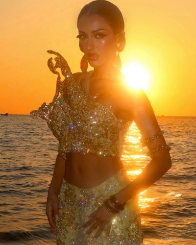 Seerat Saini wears a golden crop top with a graceful skirt.