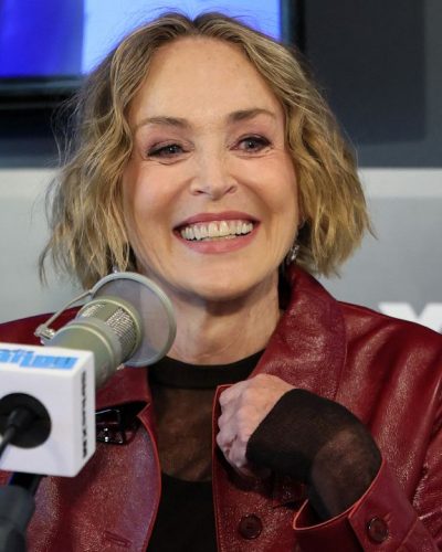 Sharon Stone in stylish pink velvet shoes and khaki pants.