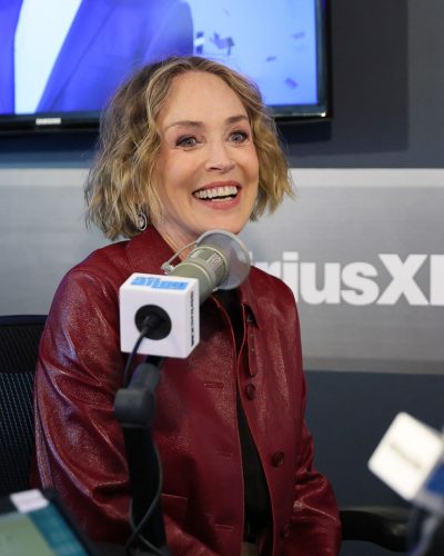 Sharon Stone in fashionable red leather jacket and brown belt.
