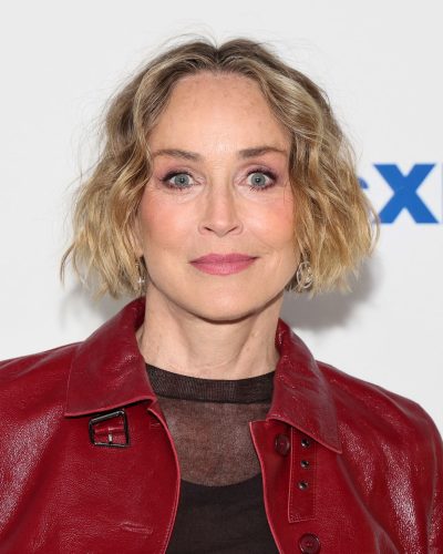 Sharon Stone in red leather jacket and black top.