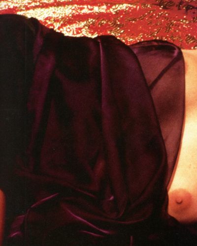 Sharon Stone white blouse featuring playful tie accents.