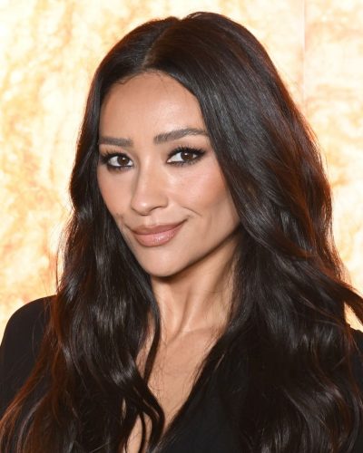 Shay Mitchell in stylish black jumpsuit with elegant neckline