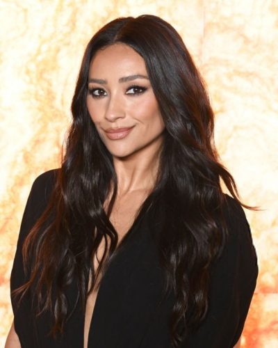 Shay Mitchell in chic black jumpsuit and classic black heels