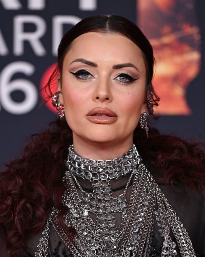 Shona McGarty in black gown complemented by bold accessories