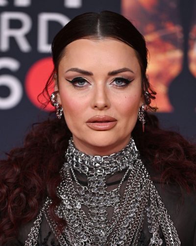 Shona McGarty with dramatic black gown and layered metallic chains
