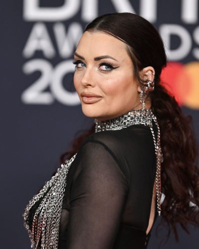 Shona McGarty in bold black gown with shimmering chain layers