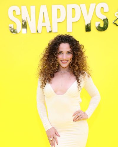 Sofie Dossi stylish yellow gown paired with nude strappy heels.