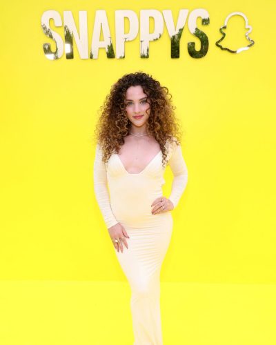 Sofie Dossi yellow long sleeve dress with deep V neckline.