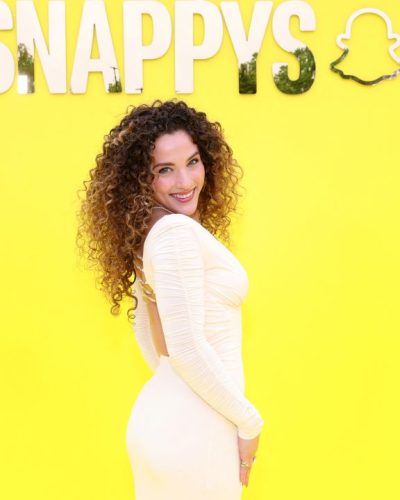 Sofie Dossi modern yellow gown paired with nude high heels.