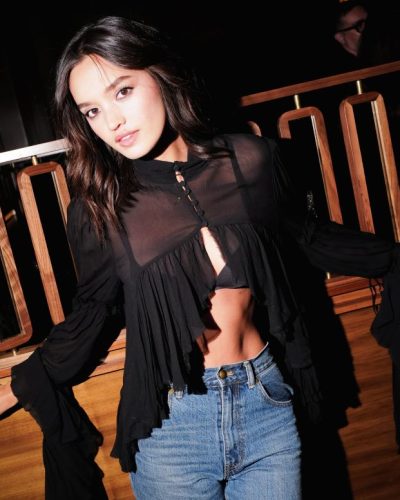 Sophia Hammons black sheer top with ruffles and blue jeans