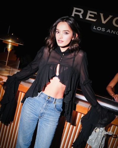 Sophia Hammons trendy black blouse with high-waisted blue jeans