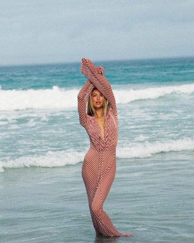 Sophia Luders fitted red and white striped gown by the ocean