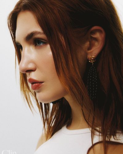 Sophie Nelisse styled in sporty red jersey and feminine lace shorts.