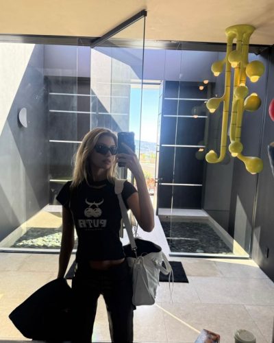 Stella Maxwell casual black crop top and stylish dark jeans.