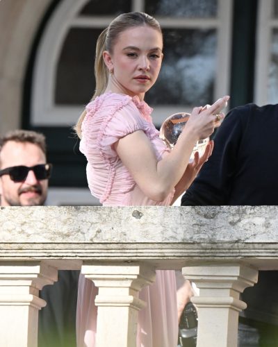 Sydney Sweeney soft pink dress with gold accents in Portugal.