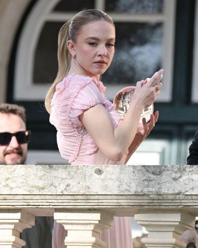 Sydney Sweeney light pink dress surrounded by beautiful landscapes.