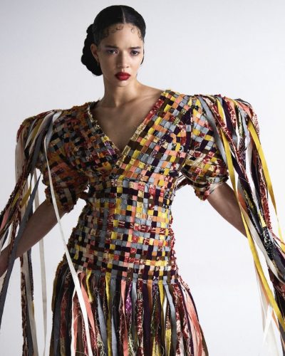 Tanzyn Crawford in colorful gown with oversized sleeves and fringes