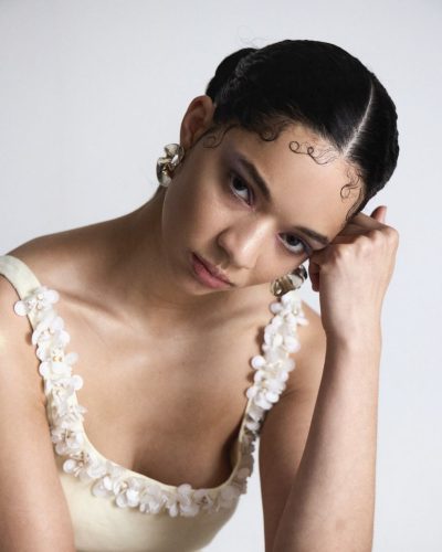 Tanzyn Crawford in low neckline dress featuring striking patterns