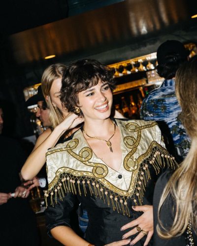 Taylor Hill black dress featuring intricate gold bead embellishments