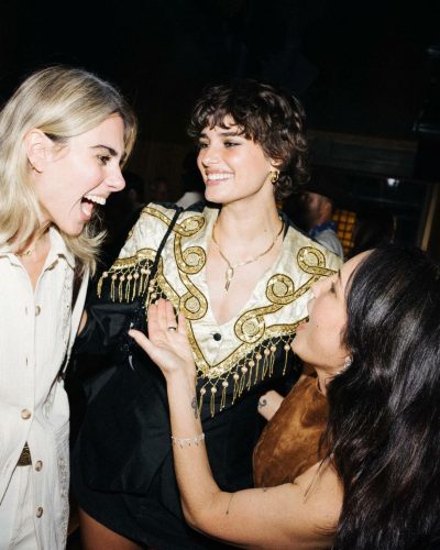 Taylor Hill knee-high black boots complementing her dress