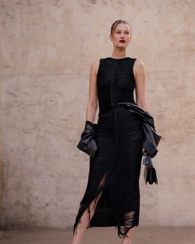 Toni Garrn in black leather coat and contemporary black ensemble.