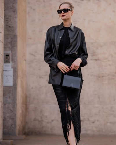Toni Garrn in black leather coat paired with simple black attire.