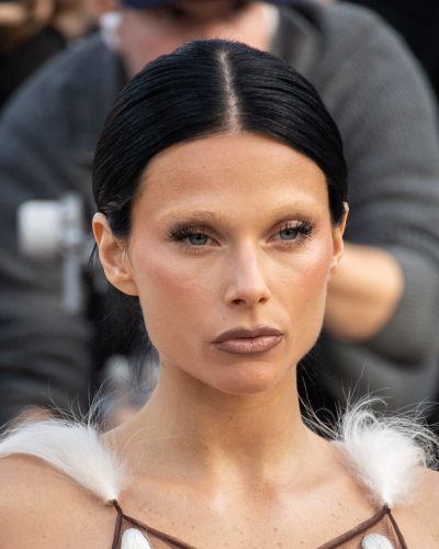 Valentina Zenere bold purple clutch contrasting with light dress.