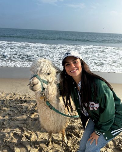 Victoria Justice in a trendy graphic cropped top and denim.