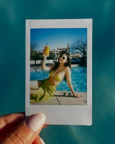 Victoria Justice wearing a colorful top and cozy denim jeans.