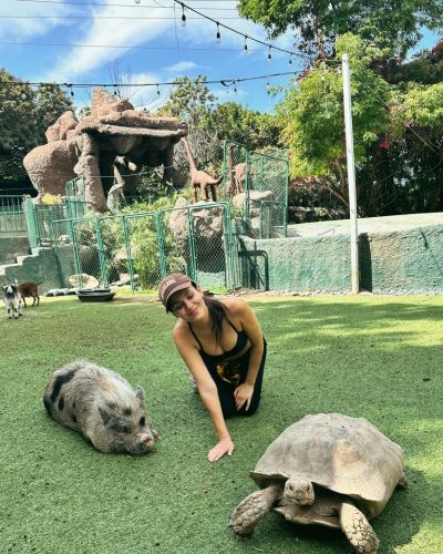 Victoria Justice in a graphic cropped top and denim jeans.