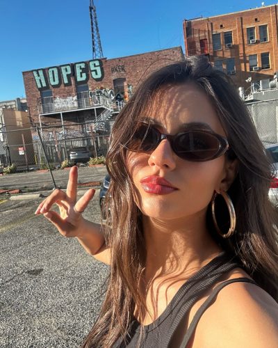 Victoria Justice with a bright cropped top and casual denim.