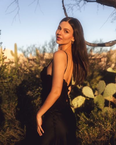 Victoria Justice in a stylish black lace gown with silver accents