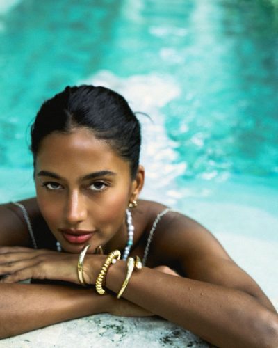 Viktoriia Pandei wearing aqua top and white flowing skirt