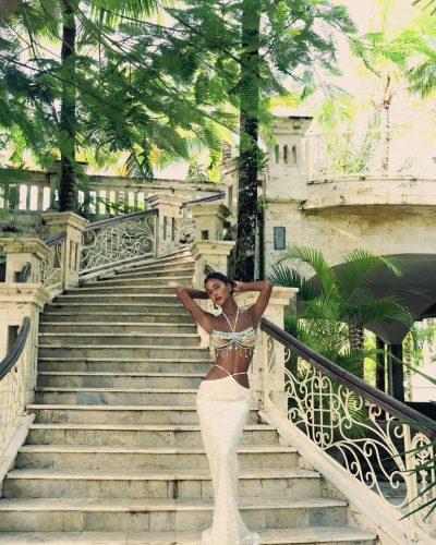 Viktoriia Pandei in aqua beaded top and white flowing dress