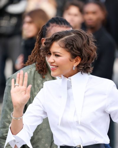 Zendaya Coleman black cinched belt against white shirt.