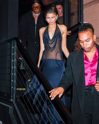 Zendaya styled in navy evening gown with soft wave hairstyle