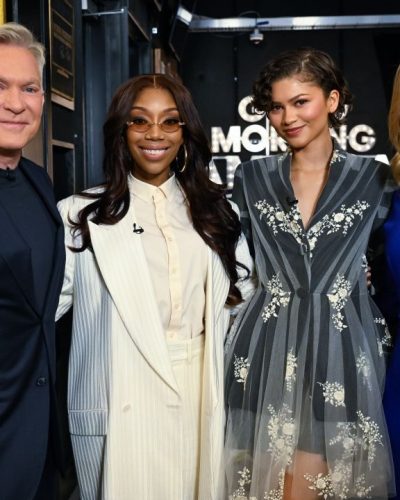 Zendaya radiant smile with gray floral dress